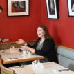 Female customer sitting at a table in The Noodle Cafe.